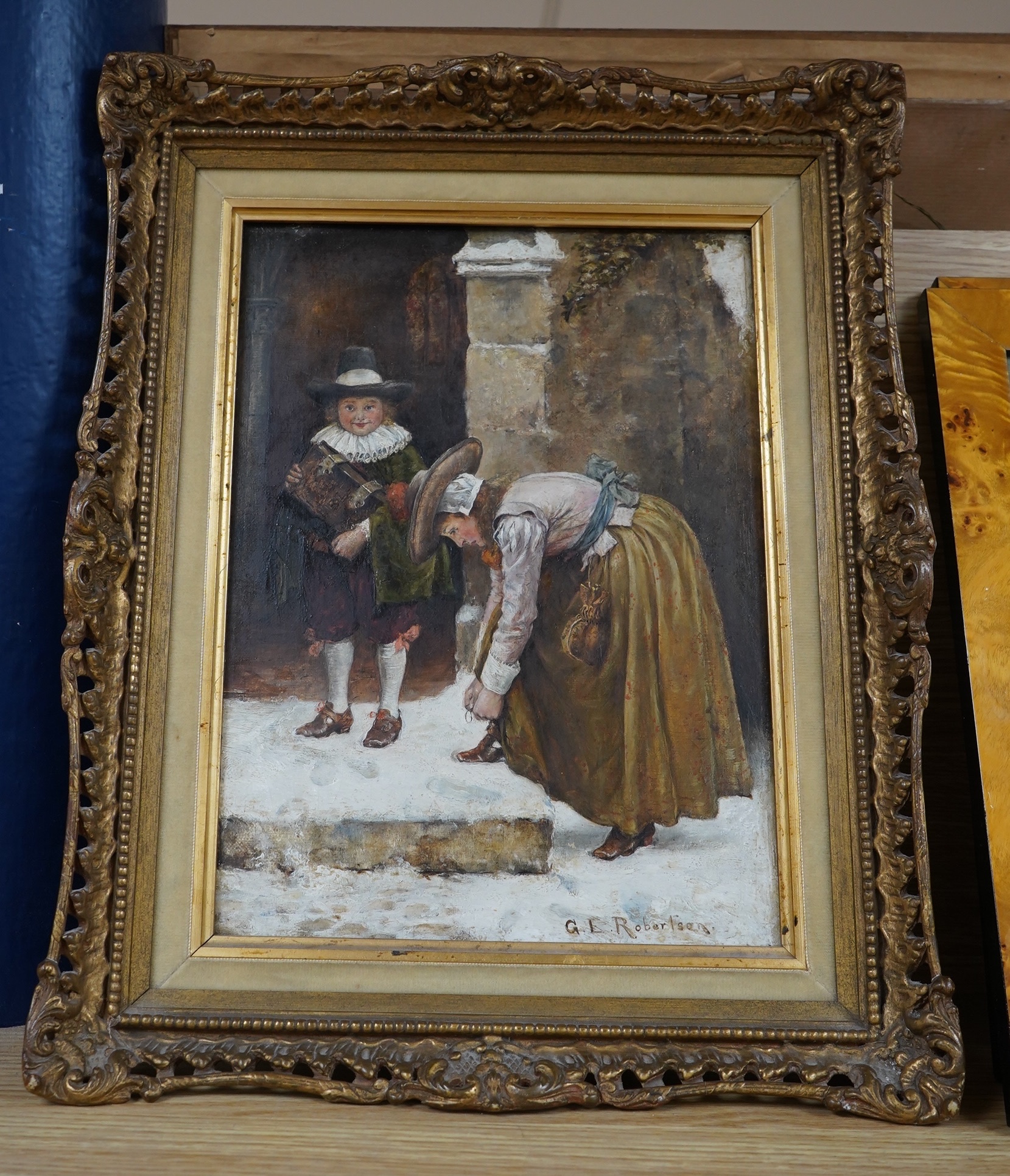 George Edward Robertson (1864-1920), oil on canvas, Winter street scene with two figures wearing 17th century dress, signed, 29 x 21cm, ornate gilt frame. Condition - good